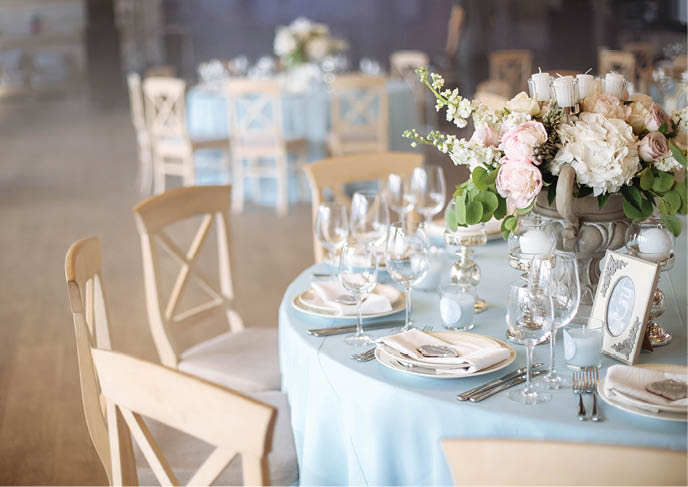 Wedding  Banquet  The chairs and round table for guests, served with cutlery, flowers and crockery and covered with a tablecloth