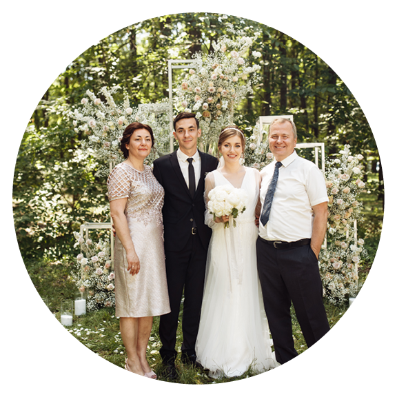 the newlyweds are photographed with family and friends  large group of people  A beautiful bride with a handsome groom is photographed with guests of different ages and nationalities against
