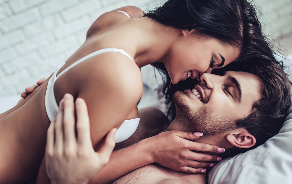 Happy couple is lying in bed together  Enjoying the company of each other 