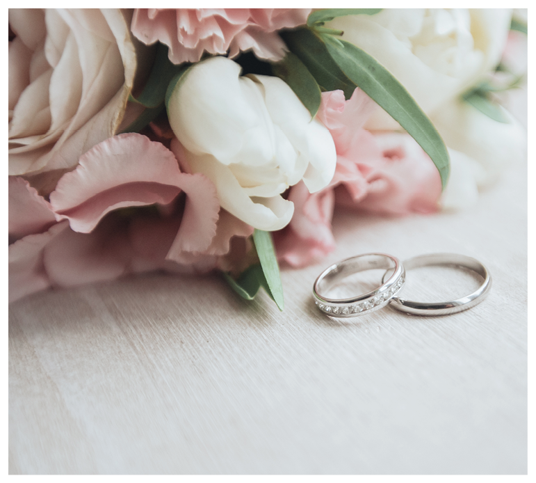 Bouquet with beautiful roses and wedding rings