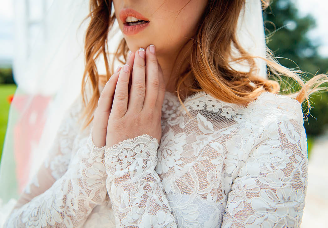 beautiful bride in lace dress is worried and waiting for her groom.
