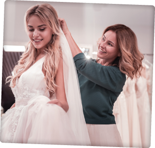 Caring mother  Happy good looking woman smiling while putting a veil on her daughters head