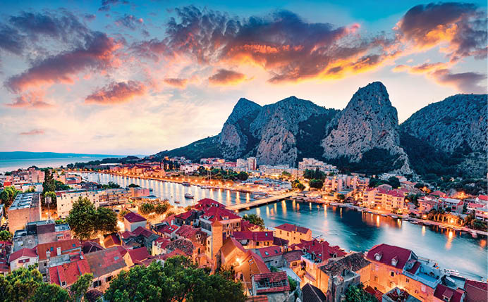 Aerial evening cityscape of old croatian resort - Omis town  Fantastic summer seascape of Adriatic sea, Dalmatia coast, Croatia, Europe  Beautiful world of Mediterranean countries  