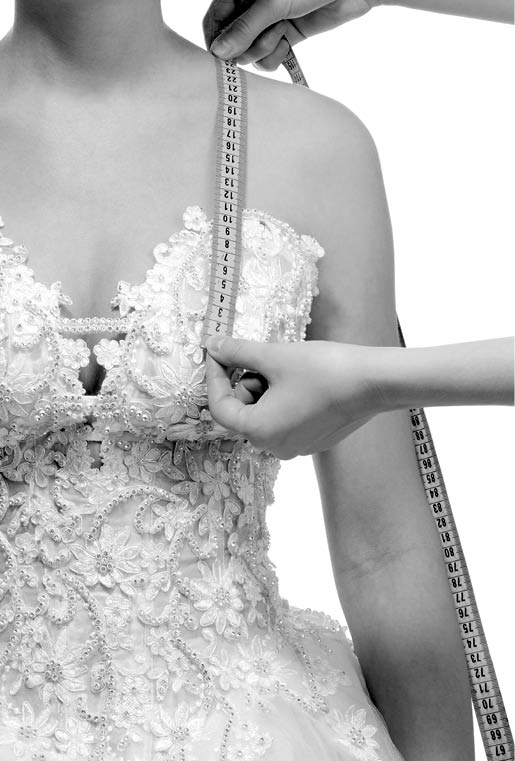 Measuring the distance from shoulder to breast with centimeter, isolated on white