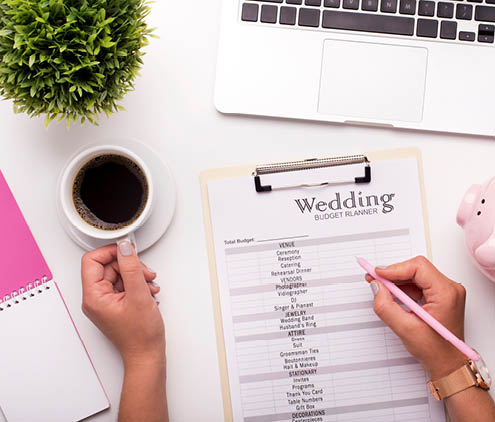 Collecting money concept. Woman planning budget before wedding writing ideas on paper