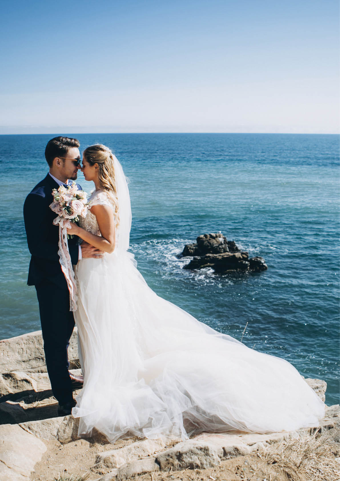 Beautiful wedding couple on their wedding photoshoot by the sea