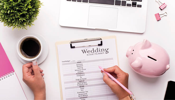 Collecting money concept  Woman planning budget before wedding writing ideas on paper