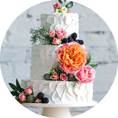 White wedding cake with flowers and blueberries