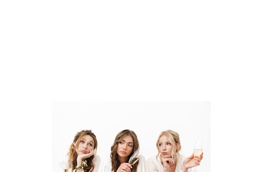 Photo of tired beautiful bridesmaids sitting and drinking champagne isolated over white wall