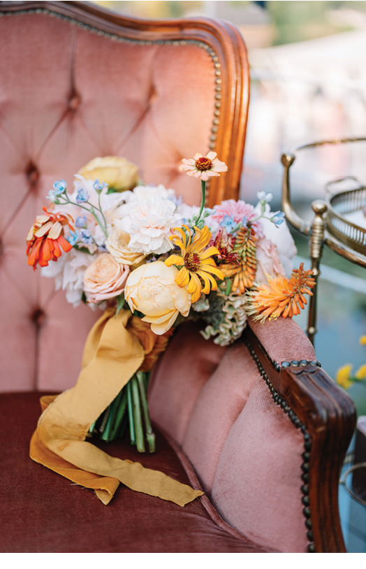Wedding. Bridal bouquet of autumn flowers with brown ribbons on a vintage chair