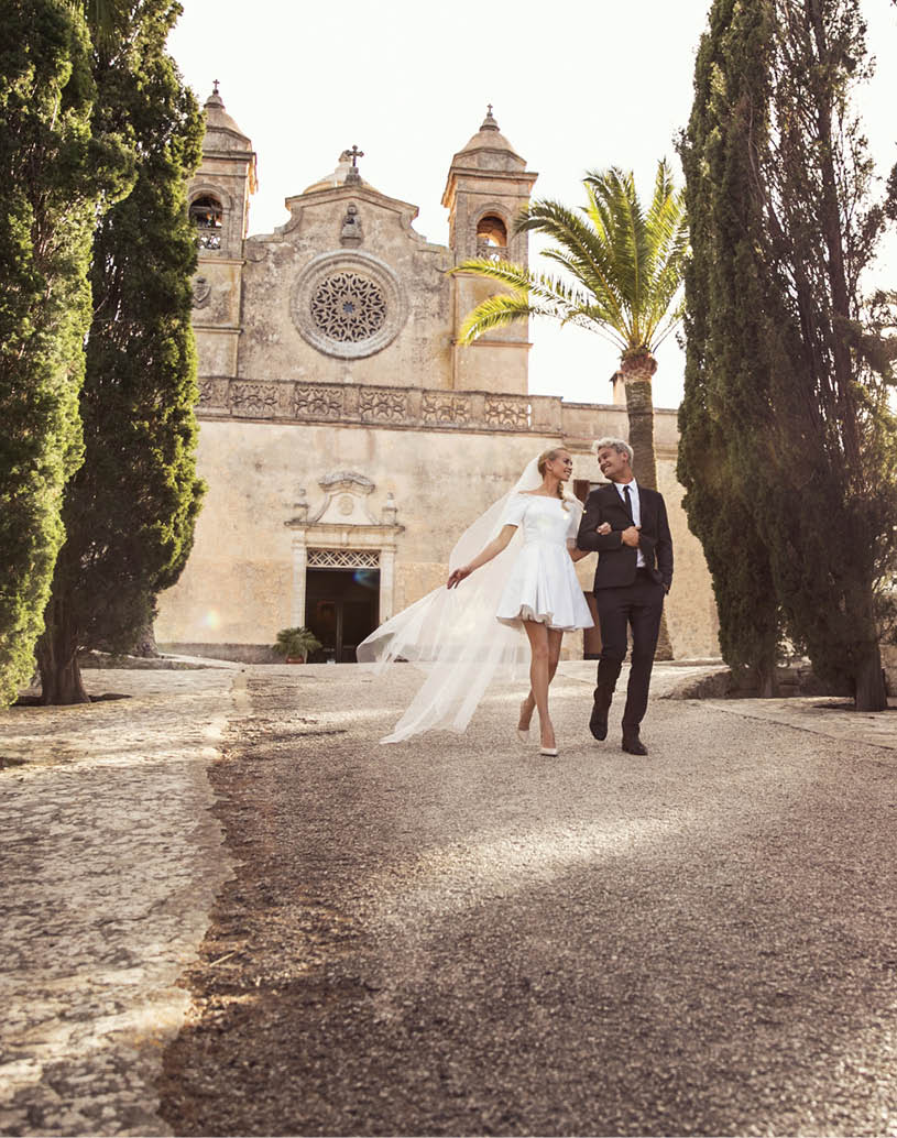 Fashionable wedding couple near Catholic church. Bride and Groom. Outdoor portrait