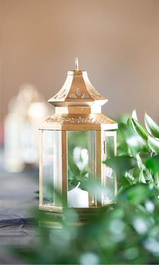 Gold ornate lantern centerpieces on wedding reception table