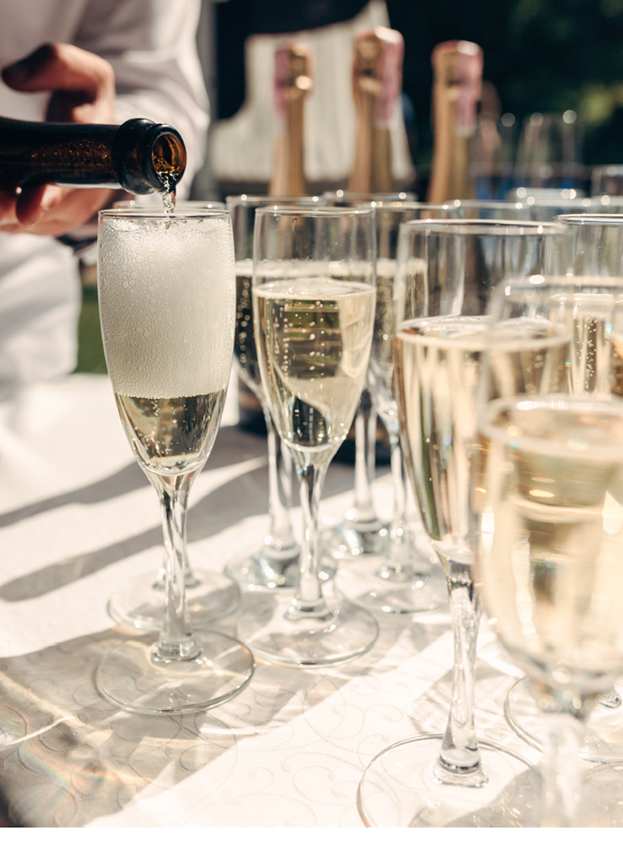 catering. beautiful glasses of champagne with bubbles on the table in the sun. serving. party. wedding.