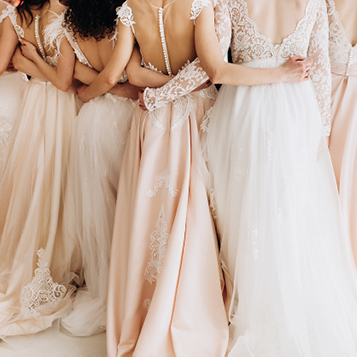 close-up of a girl in wedding dresses are standing with her back and arms hugging her waist