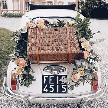 Back of a vintage wedding car with suitcase and decoration ideas to celebrate the best Just married.