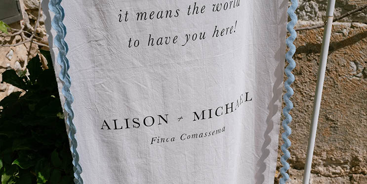 A blue and white towel with the words “It means the world to have you here" written on it. Description generated by AI