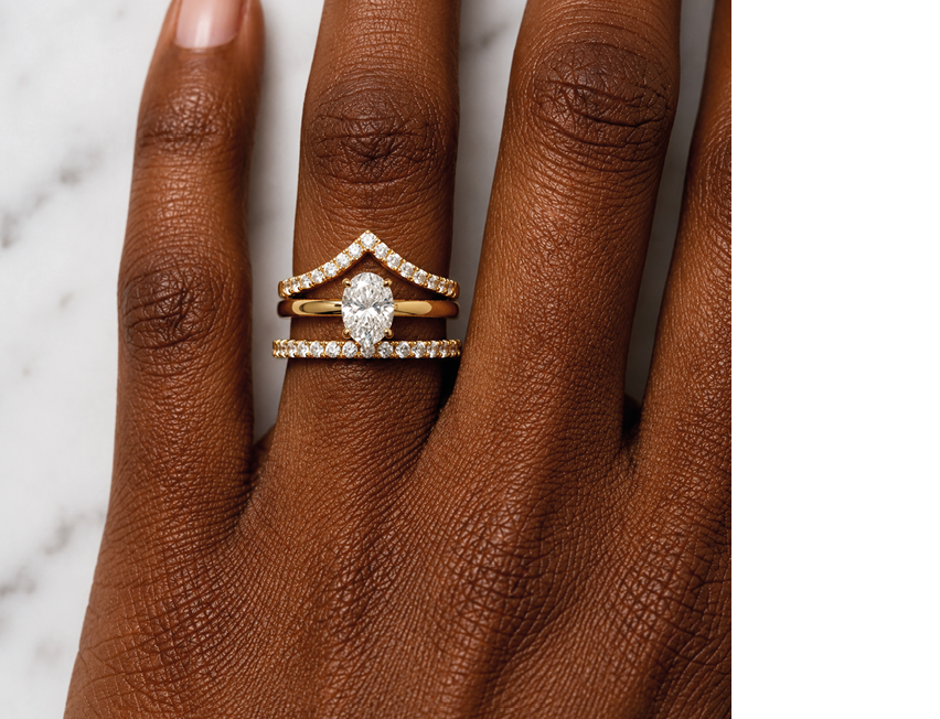 A woman's hand with a ring on her finger. Description generated by AI