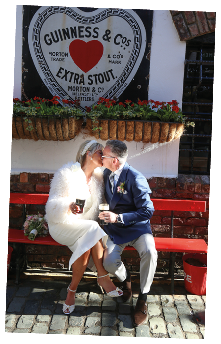 A man and woman sitting on a bench. Description generated by AI
