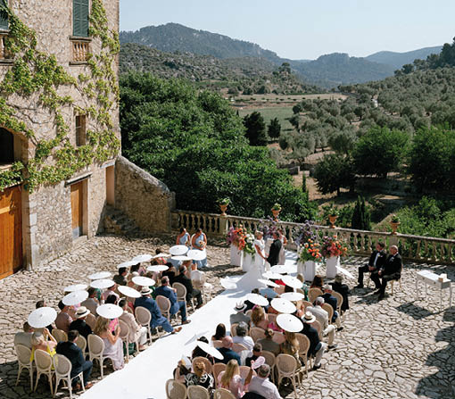 A group of people are sitting at tables on a patio. Description generated by AI