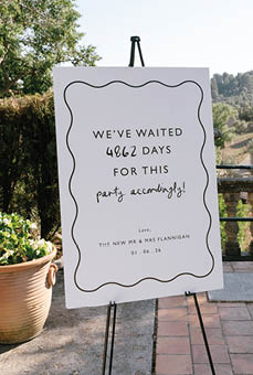 A sign on a stand with a white background and black lettering. Description generated by AI