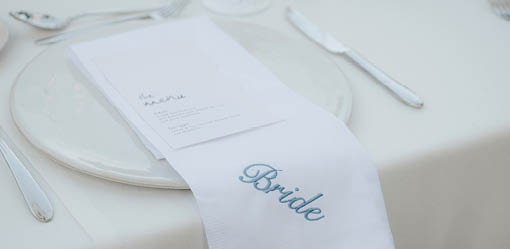 A napkin with the word “Bride" written on it. Description generated by AI