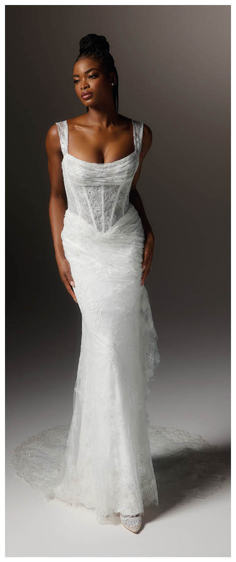 A woman in a white dress with a train. Description generated by AI