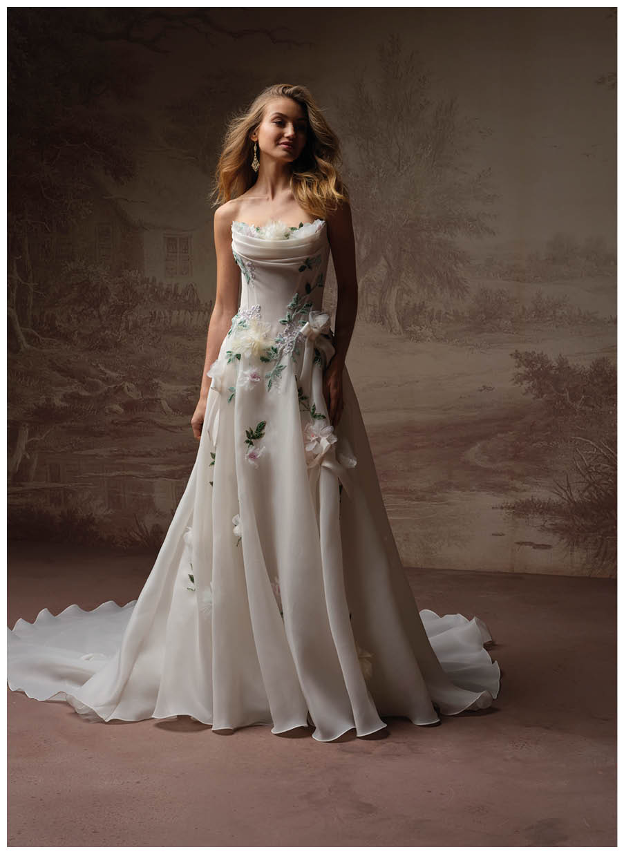 A woman in a white dress with a flower design. Description generated by AI
