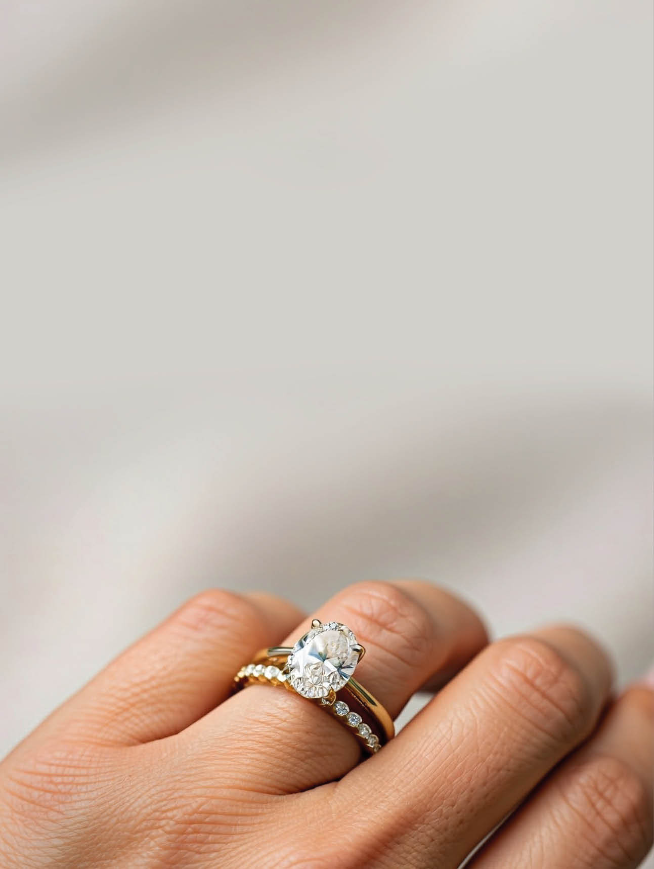 A person is holding a ring with a diamond on it. Description generated by AI