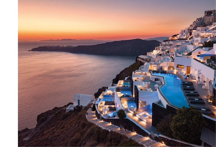 A large white building with a pool and a blue roof. Description generated by AI