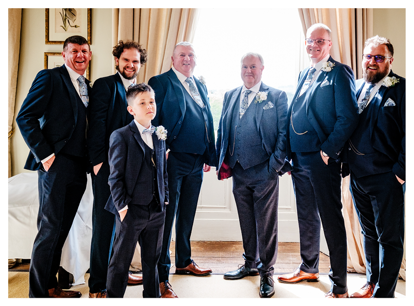 A group of men wearing suits and ties. Description generated by AI