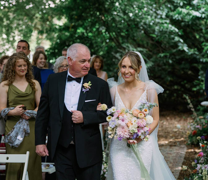 A bride and groom walking down the aisle. Description generated by AI