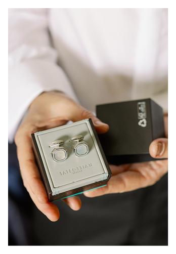 A man holding a box with a pair of glasses in it. Description generated by AI
