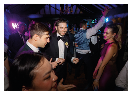 A group of people are dancing in a room. Description generated by AI