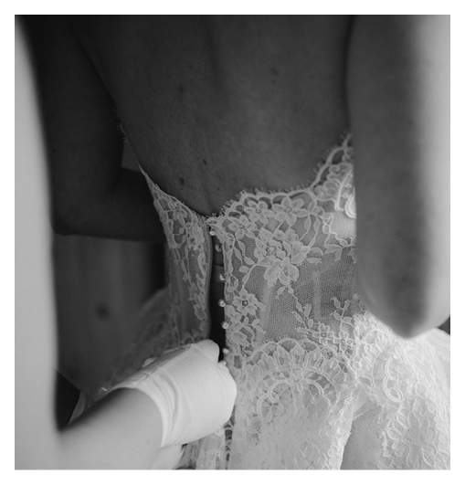 A bride and groom kissing in front of a church. Description generated by AI