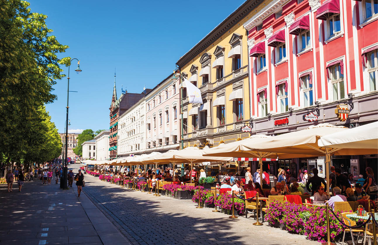 A city street with a row of tables and chairs. Description generated by AI