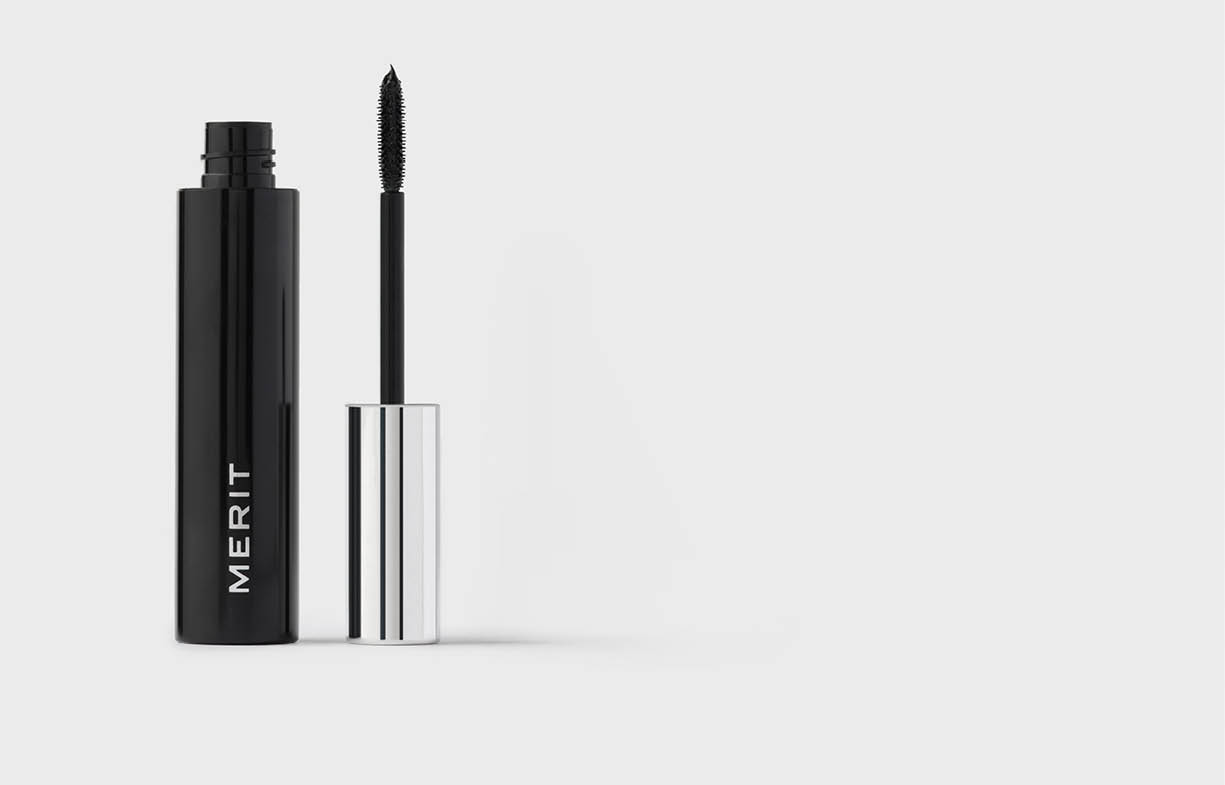 A black eyeliner and a white tube of lipstick. Description generated by AI