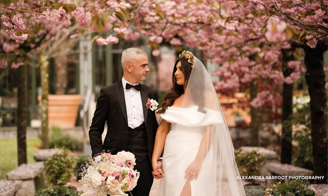 A man and woman are standing in front of a tree. Description generated by AI
