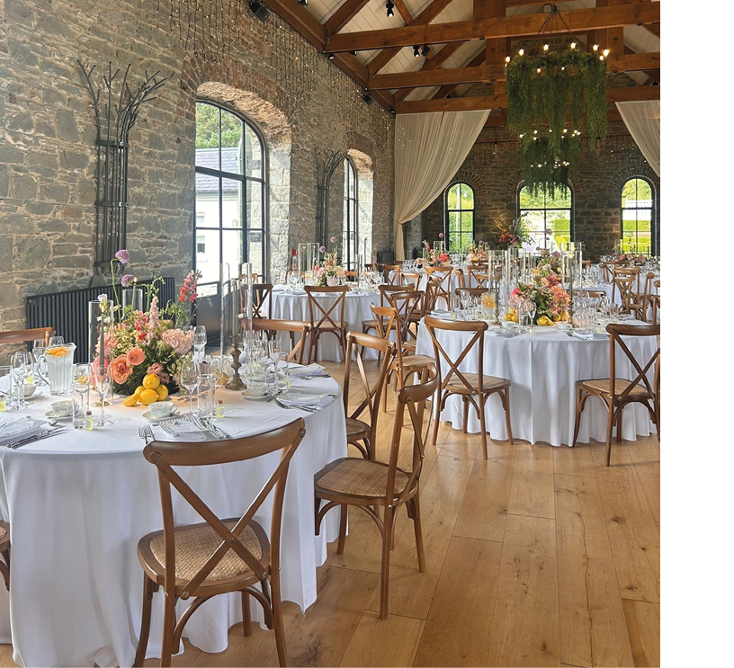 A large room with a long table set for a dinner. Description generated by AI