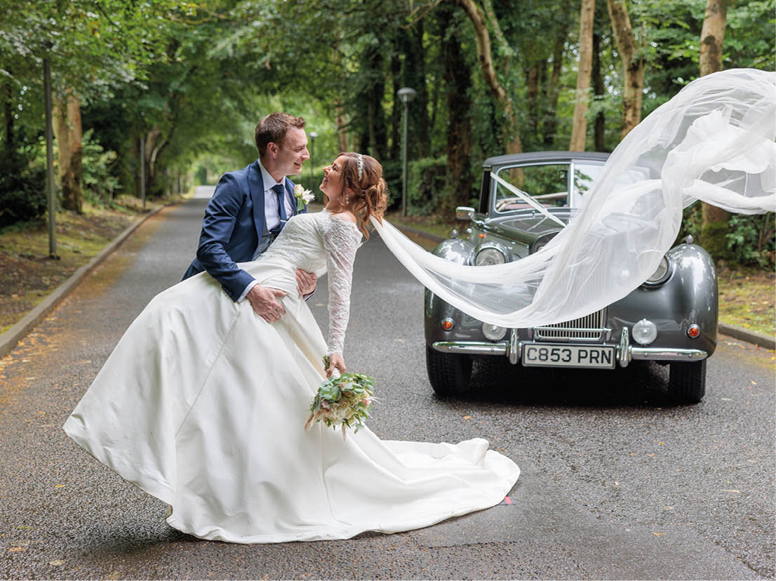 A bride and groom are dancing on a street. Description generated by AI