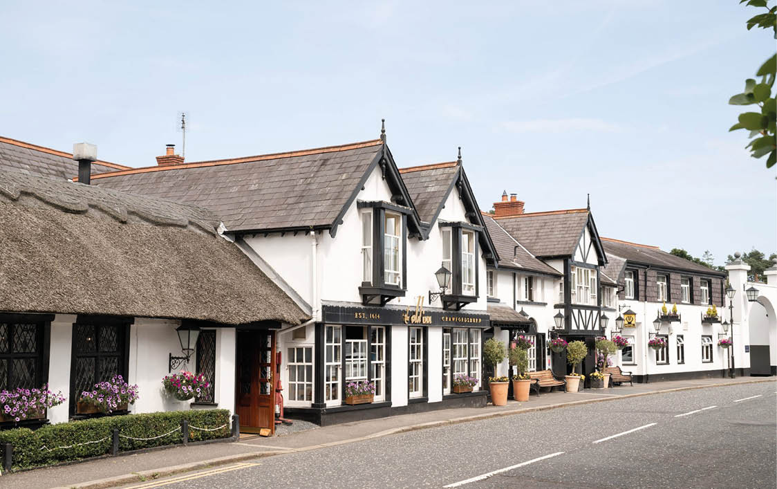 A street with white buildings and a black roof. Description generated by AI