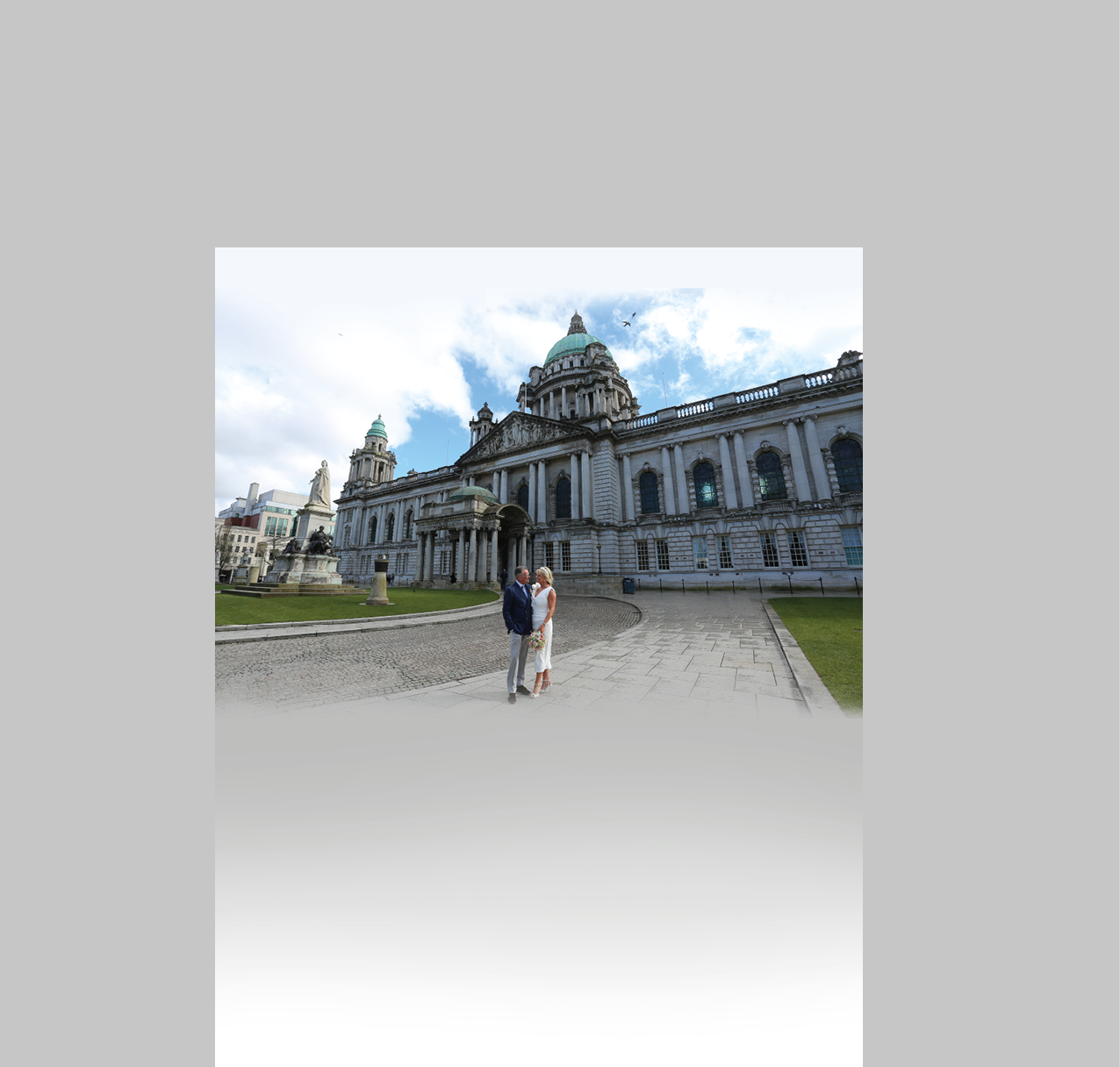 A man and woman standing in front of a building. Description generated by AI