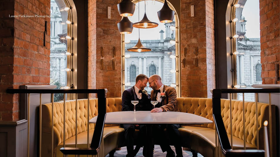 A man and woman sitting at a table in a restaurant. Description generated by AI