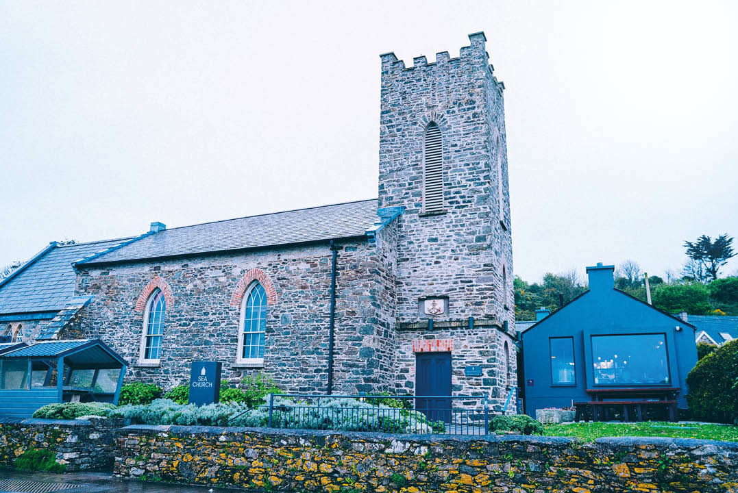 A large stone building with a clock tower. Description generated by AI