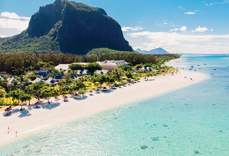 Luxury tropical beach and Le Morne mountain in Mauritius. Beach with palms and ocean. Aerial view