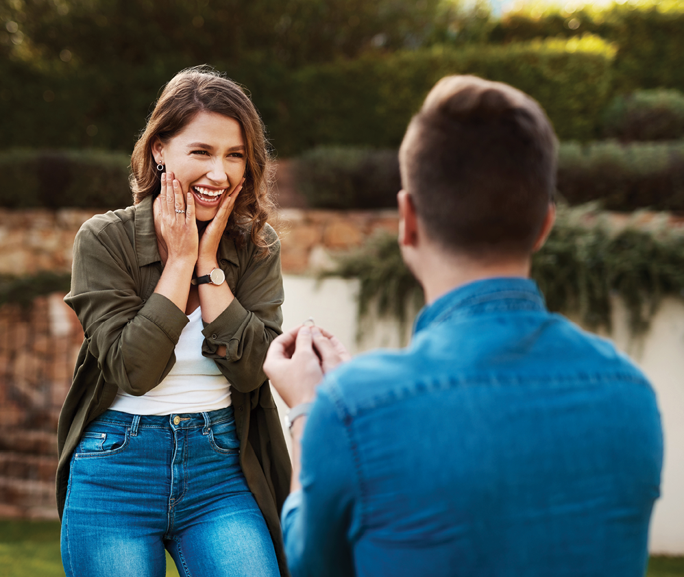 Love, surprise and engagement with couple in nature for wedding, commitment and happiness. Smile, proposal and offer with man and woman in backyard of home for marriage, wow and save the date