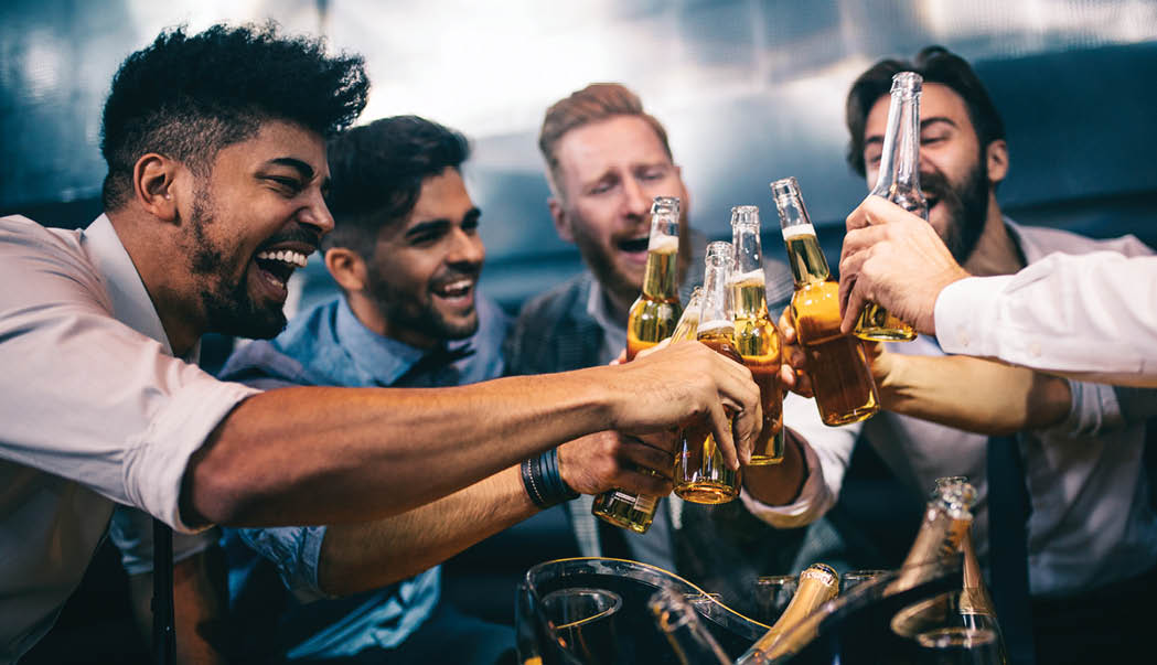 Group of young men toasting at a nightclub