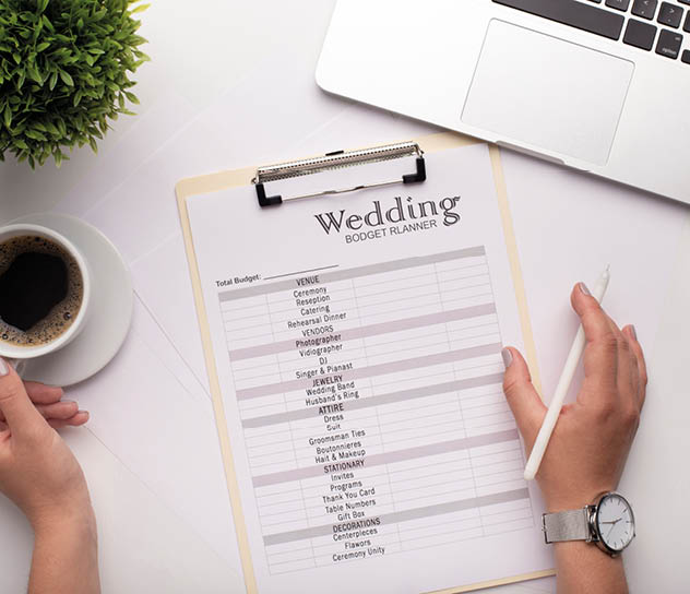 Wedding arrangement background. Female hands preparing for marriage, using laptop and drinking coffee, white workplace