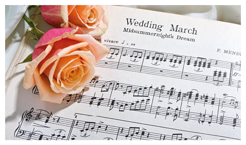 Sheet music of the Wedding March with roses and rings