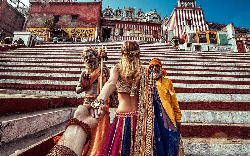 woman leading man up steps