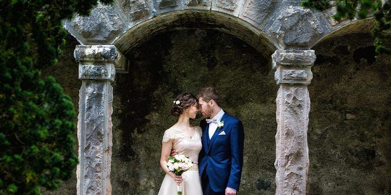 bride and groom under arcg